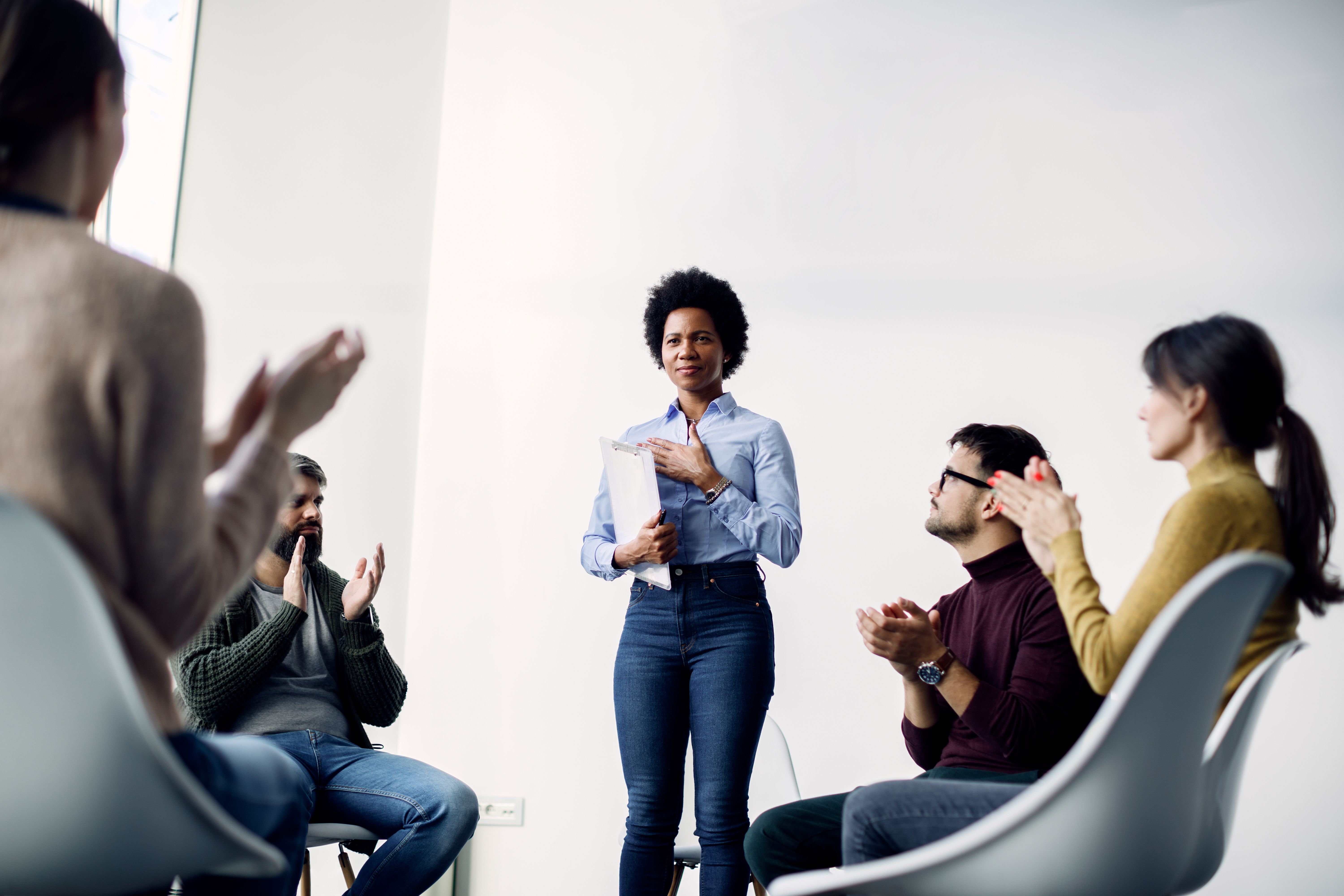african-american-female-psychotherapist-getting-applause-after-successful-group-therapy.jpg